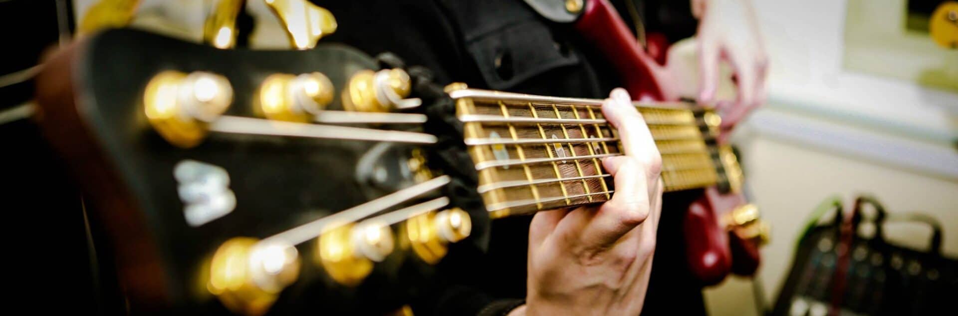 The Slap'n'Pop Music studio in Sheffield with bass, guitar, drums, and recording equipment