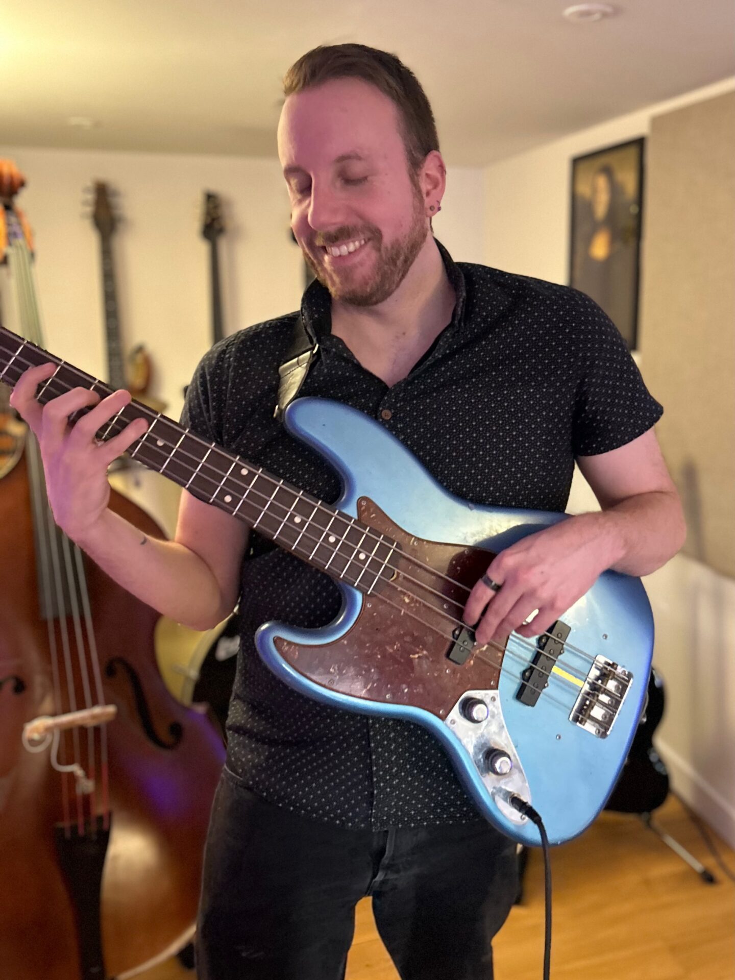 Adam playing the bass guitar during a music lesson in Sheffield.