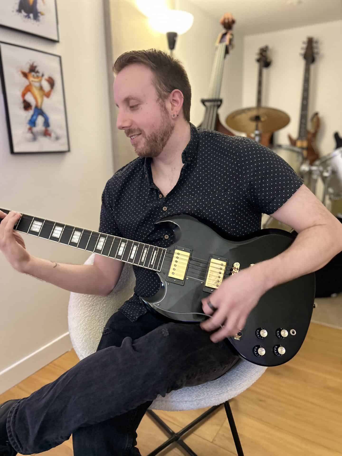 Adam Porter playing guitar at the Slap'n'Pop Music studio in Sheffield