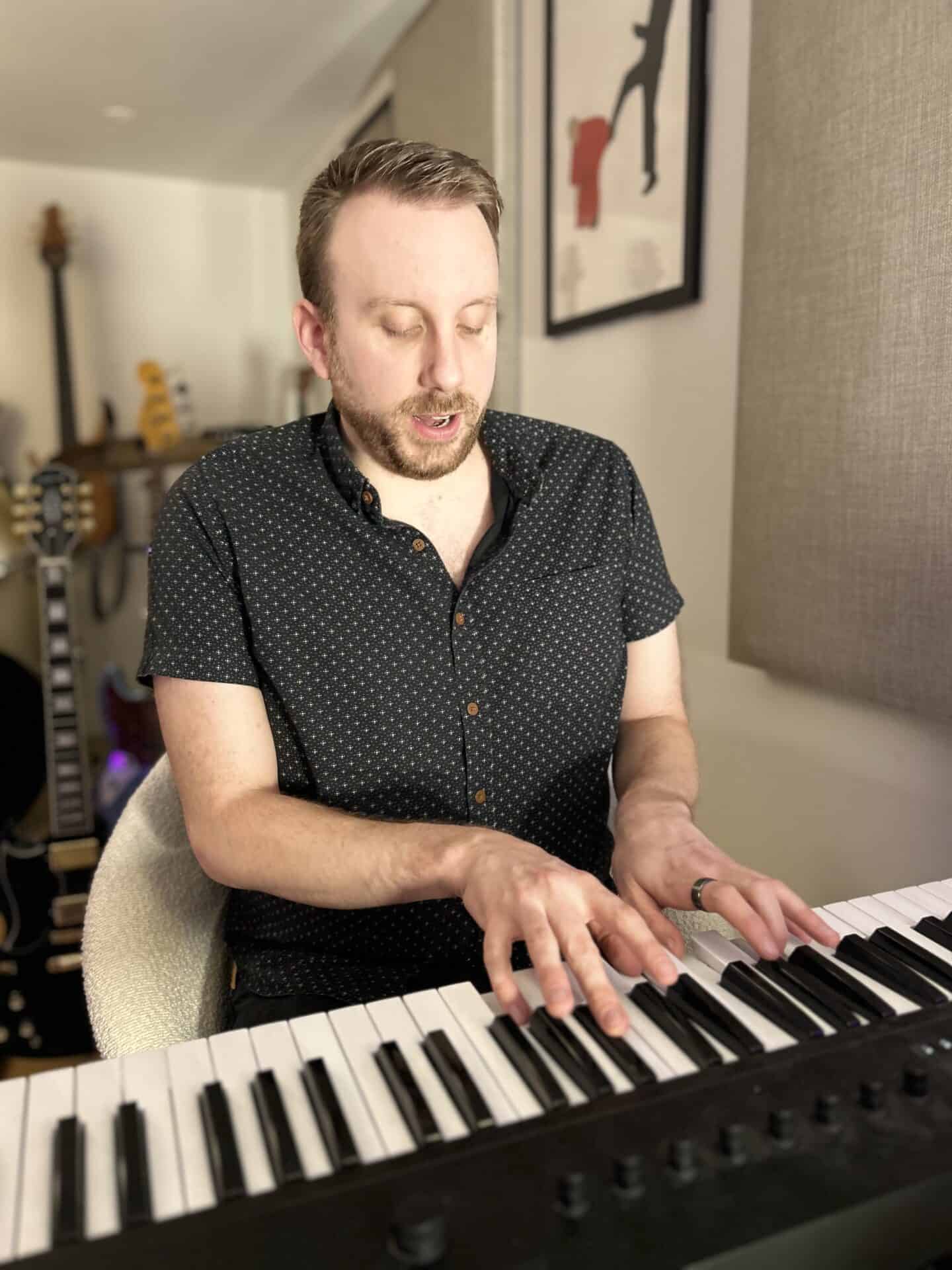 Adam Porter playing piano at the Slap'n'Pop Music studio in Sheffield